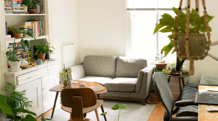 gray fabric loveseat near brown wooden table