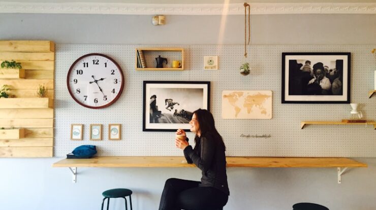 woman sitting on stall near wall mounted desk