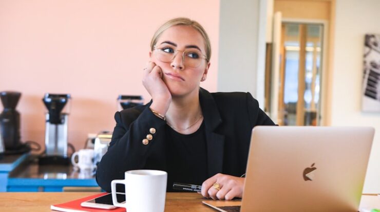 woman in black long sleeve shirt using macbook