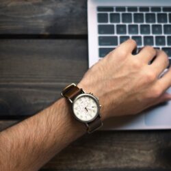 person wearing brown and white watch