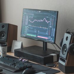 black flat screen computer monitor turned on beside black computer keyboard